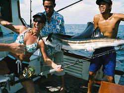 Female angler with a Sailfish on a day charter